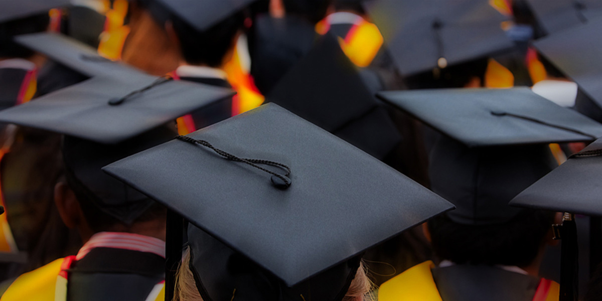 Overhead photo of graduation caps at a commencement ceremony.